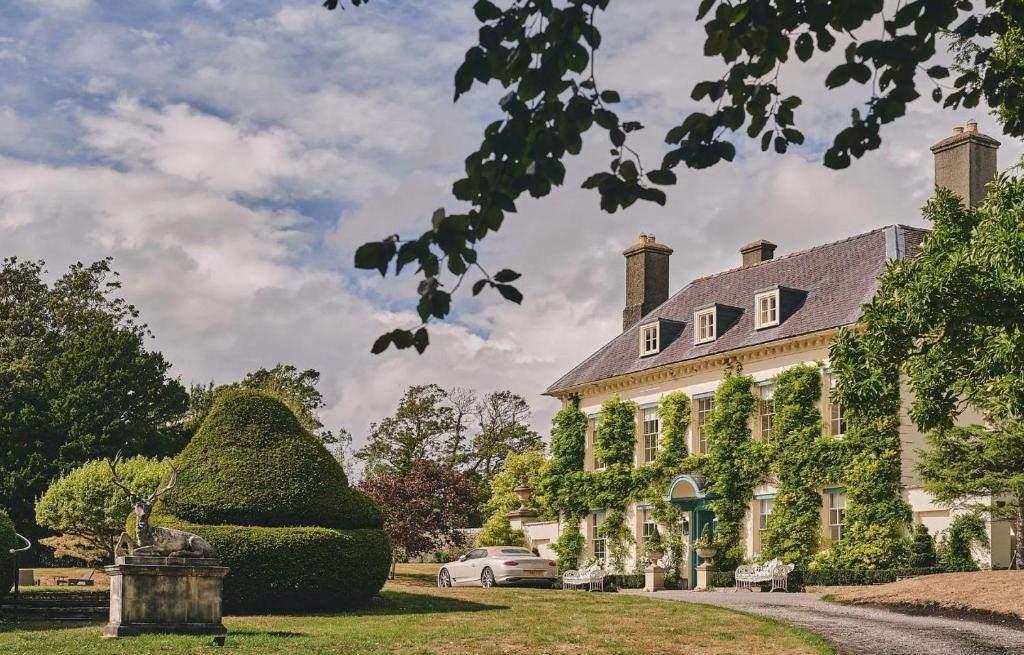 a large house with a car parked in front of it at Aspen Suite in Barry