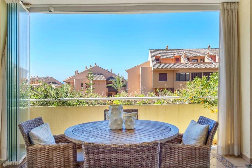 a table and chairs on a balcony with a view at modern apartment by the sea.(Marbella) in Marbella