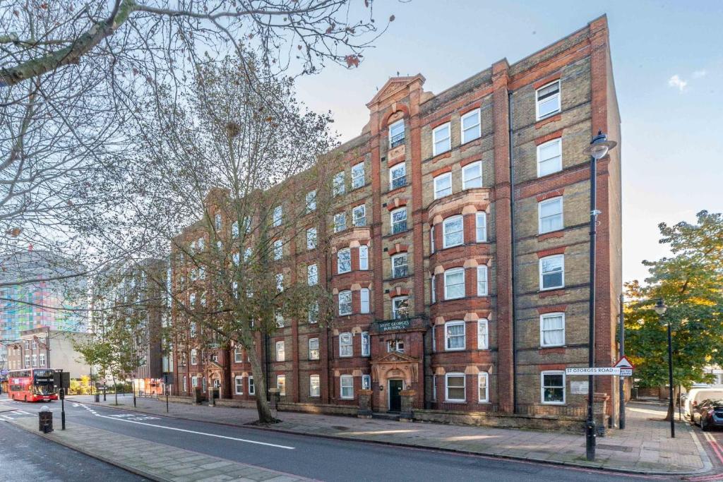 a large brick building on a city street at Bright and Cosy Apartment in South London in London