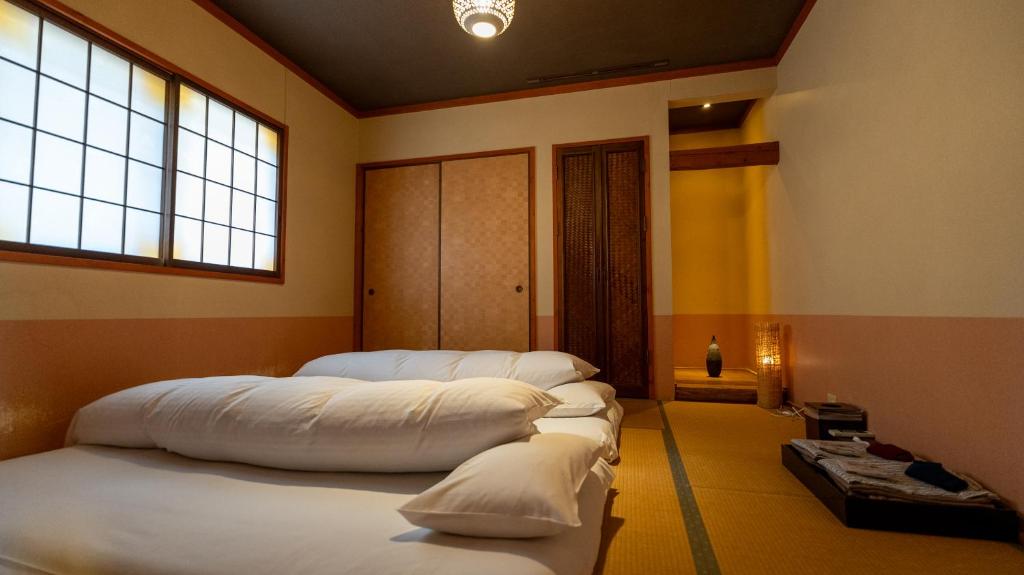 Postel nebo postele na pokoji v ubytování ほたるの長屋