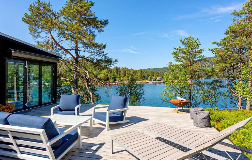 a patio with chairs and a view of a lake at 4 Bedroom Lovely Home In Skodje in Skodje