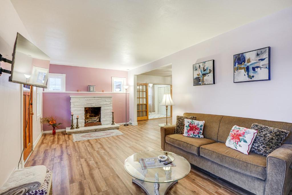 a living room with a couch and a fireplace at Pet-Friendly Syracuse Home with Private Yard! in Syracuse