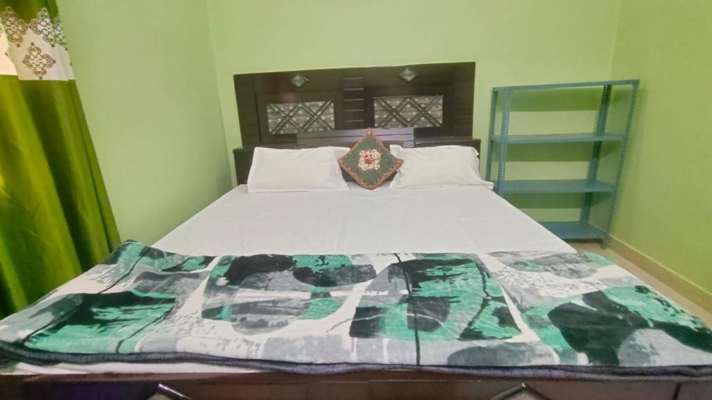 a large bed in a room with at Prakash Homestay in Ayodhya