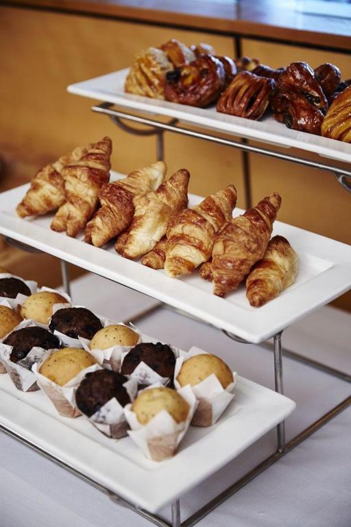 a display of pastries and croissants and other pastries at PFA Hotel Viareggio in Viareggio