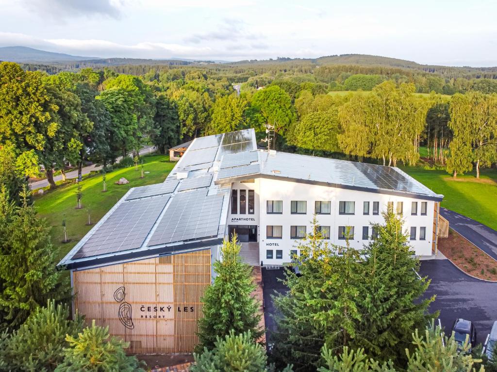 an aerial view of a building with solar panels on it at Resort Český les in Bělá nad Radbuzou