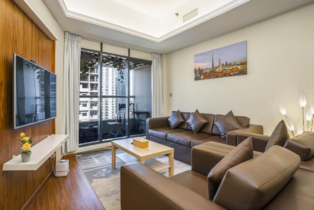 a living room with a couch and a table at ZAPBED House - AWP 1501 in Dubai