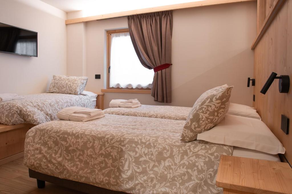 Rúm í herbergi á Chalet al Tabià