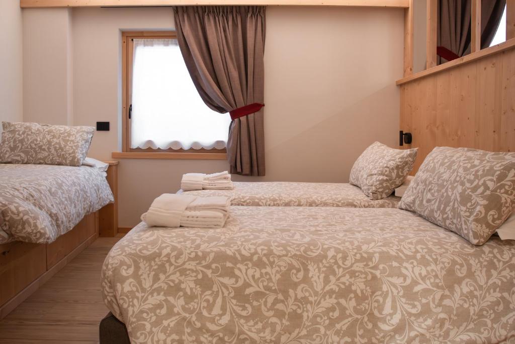 Rúm í herbergi á Chalet al Tabià