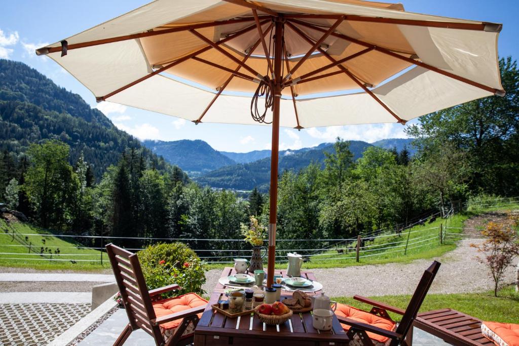 a table with an umbrella on a patio at Chalet Alte Schmiede in Göstling an der Ybbs