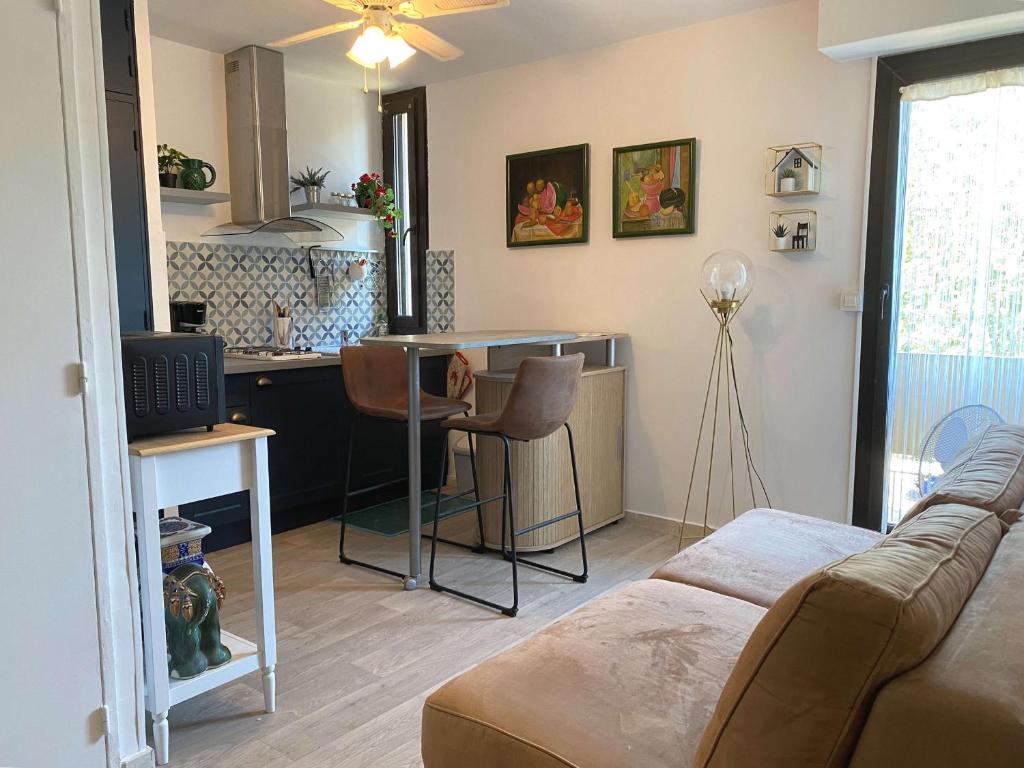 un salon avec un canapé et une cuisine dans l'établissement Charmant T2 avec parking à Balaruc-les-Bains - FR-1-553-212, à Balaruc-les-Bains