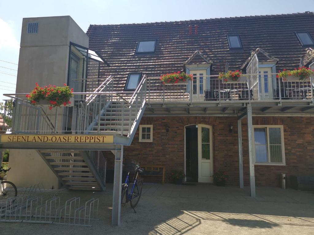 a brick building with stairs and a apartment at Seenlandoase Reppist in Senftenberg