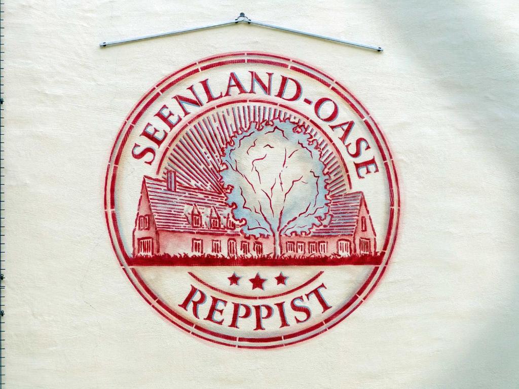 a red and white sign on the side of a building at Seenlandoase Reppist in Senftenberg