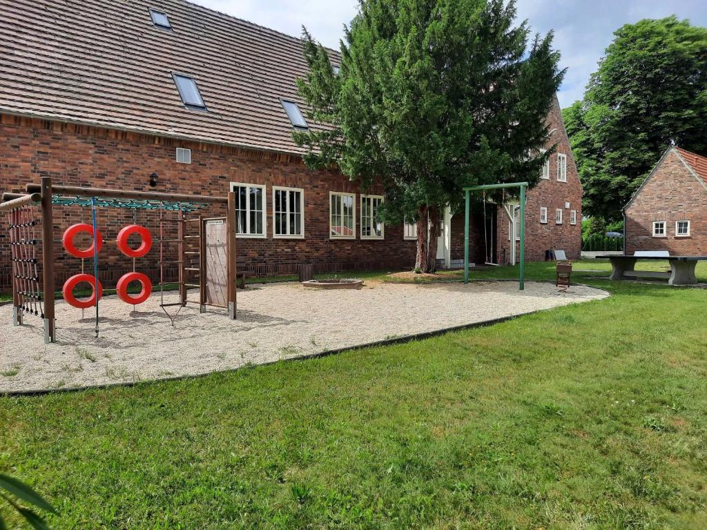 a park with red frisbees in front of a brick building at Seenlandoase Reppist in Senftenberg