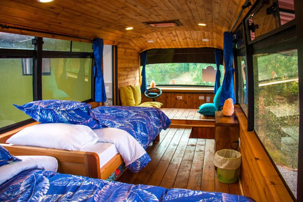 a bedroom with two beds in an rv at Los Nopales Glamping in Sáchica