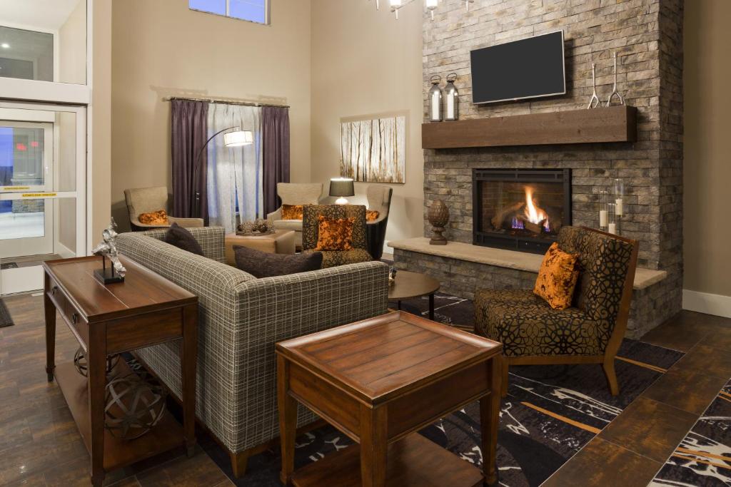a living room with a couch and a fireplace at GrandStay Hotel & Suites - Morris in Morris