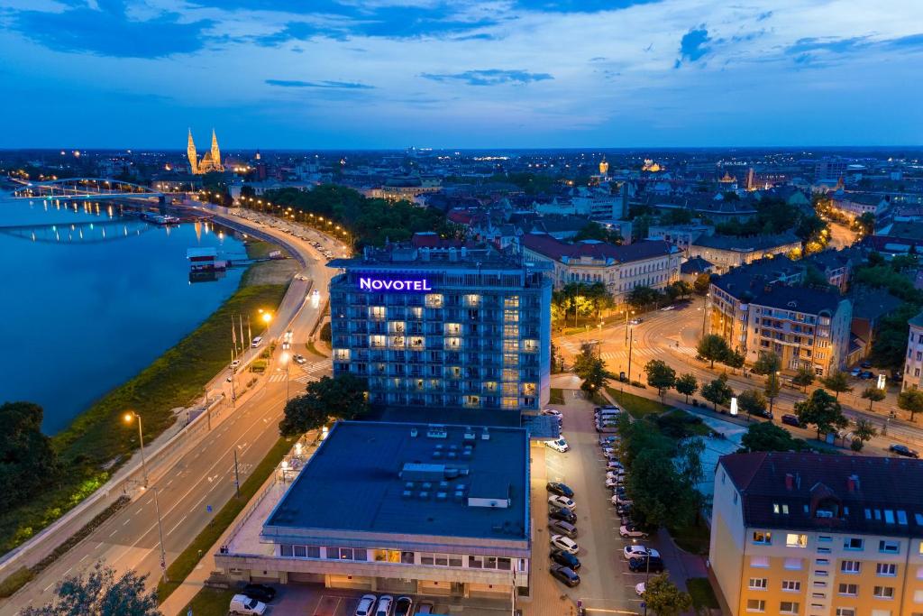 an aerial view of a city at night at Novotel Szeged in Szeged