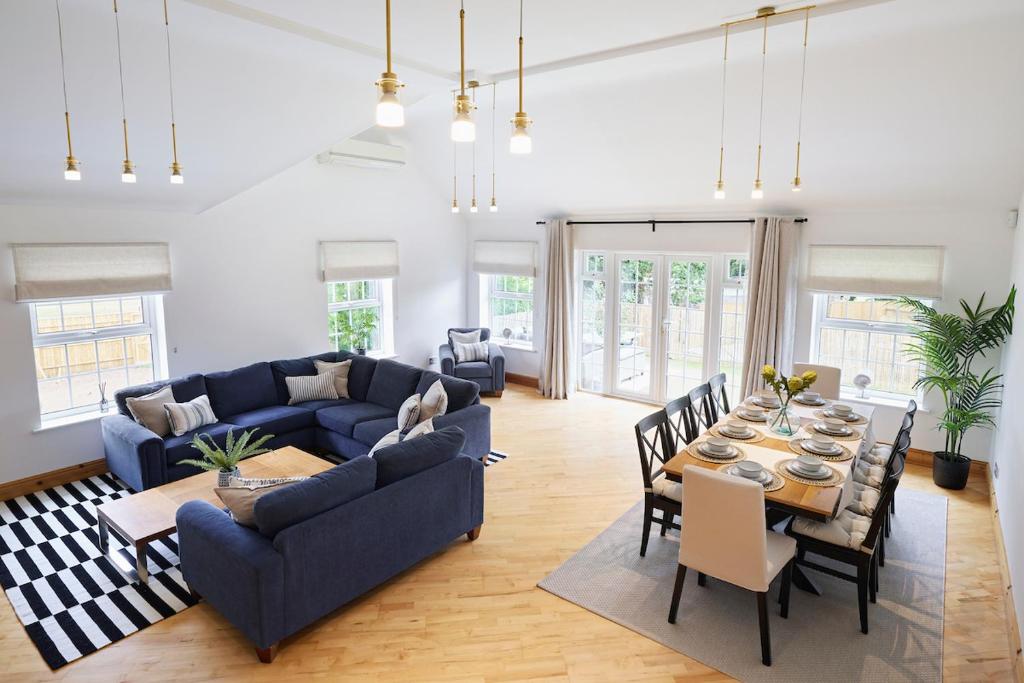 a living room with a blue couch and a table at The Castleman in Ferndown