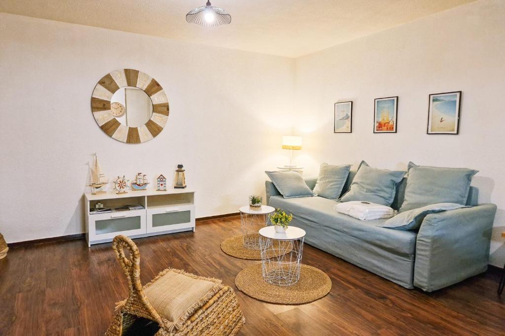 a living room with a blue couch and a table at #L8 Le Montorge City center Studio Fully equipped in Grenoble