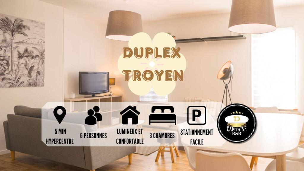 un soggiorno con divano e tavolo di Le Duplex Troyen - 5 min Hypercentre - Ideal Groupe - Parking Gratuit a Troyes