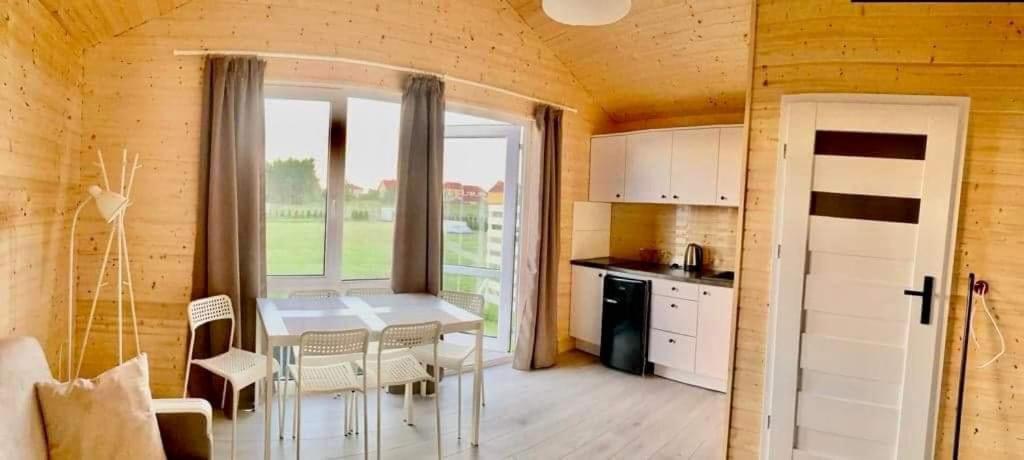 a kitchen with a table and chairs in a room at Wczasowa Gąska in Gąski