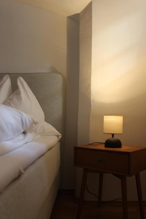 a lamp on a table next to a bed at City Center Golden Roof 5 in Innsbruck