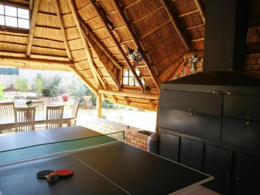 a kitchen with a table and a stove in a cabin at Chic Breeze in Bloemfontein