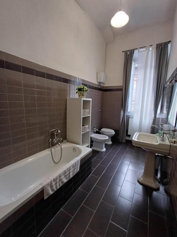 a bathroom with a tub and a toilet and a sink at B&B Home XIX in Narni