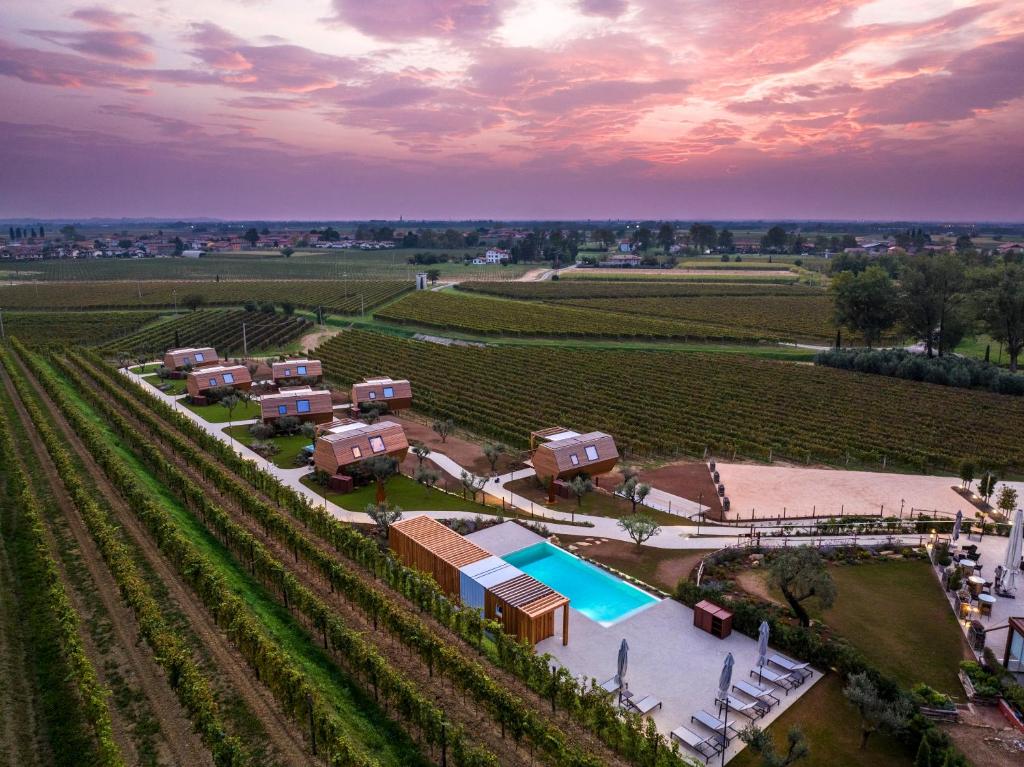 an aerial view of a farm with a pool at Glamping Alvearium Alturis in Gagliano