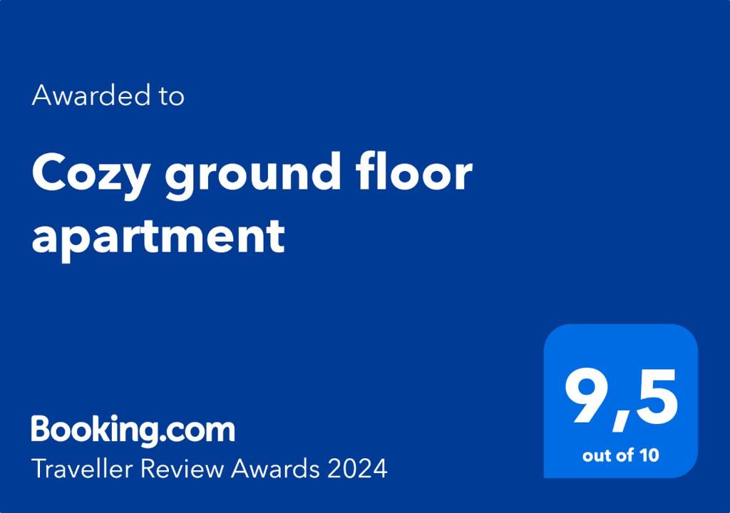 a blue sign with the words cozy ground floor apartment at Cozy ground floor apartment in Tromsø