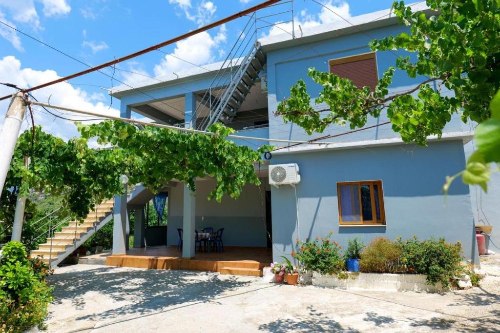 a house with a blue facade at Kalemi Sunrise Studios in Borsh