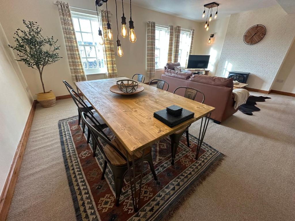 a living room with a wooden table and a couch at Riverside in Brecon