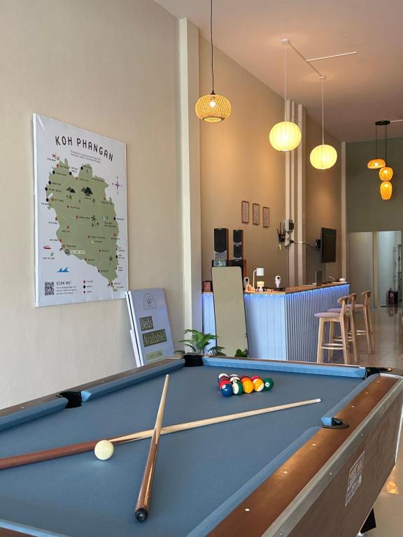 a pool table in a room with a map at Tangerine Dream Guesthouse in Koh Phangan