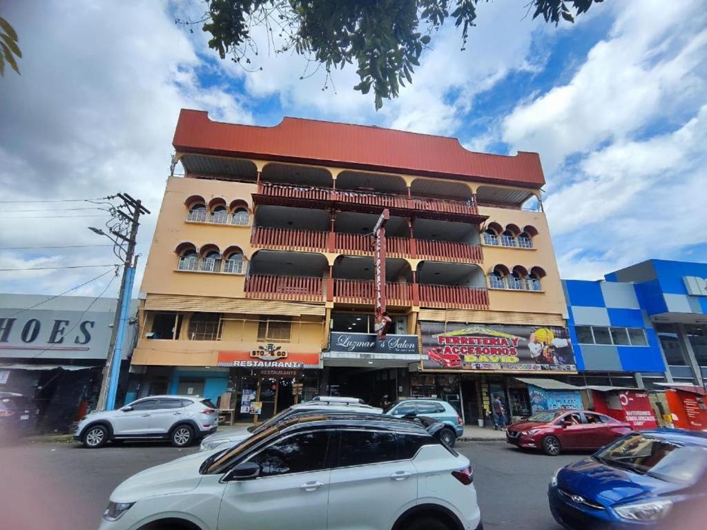 a large building with cars parked in front of it at HOTEL OCCIDENTAL David Chiriqui in David