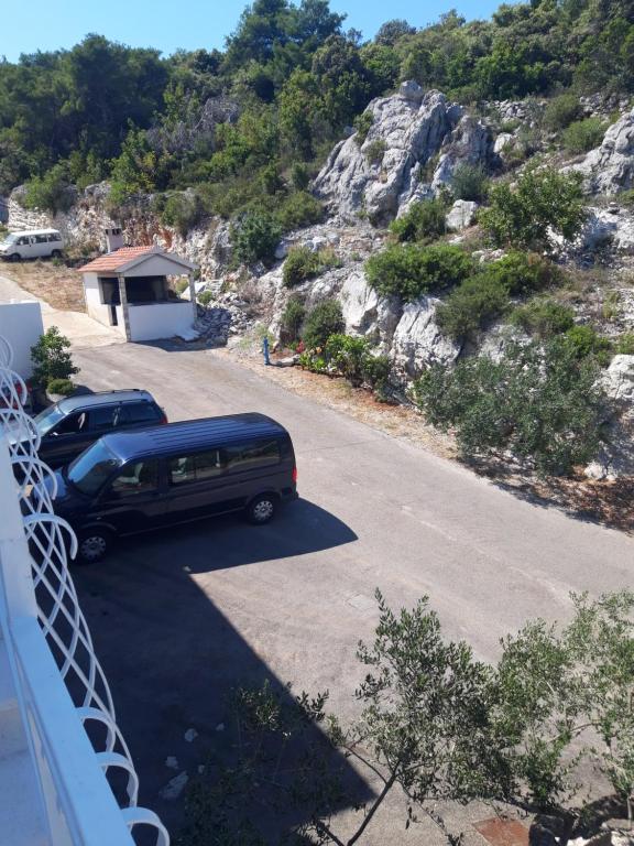 a truck parked in a parking lot next to a mountain at Villa Šolta in Rogač