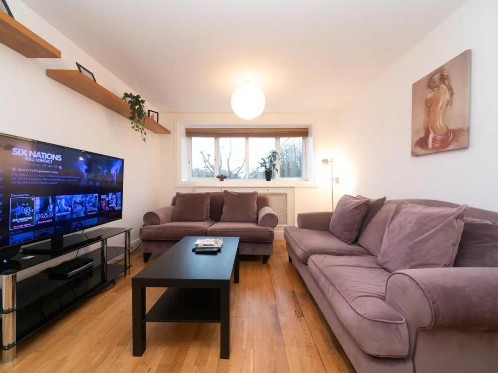 a living room with a couch and a flat screen tv at Pass the Keys Canal-view flat near Madame Tussauds in London