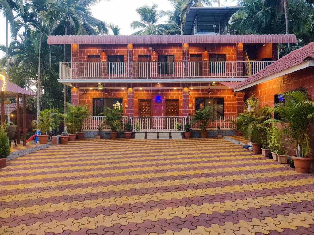 a building with a courtyard in front of it at Bhumi Cottage in Revadanda