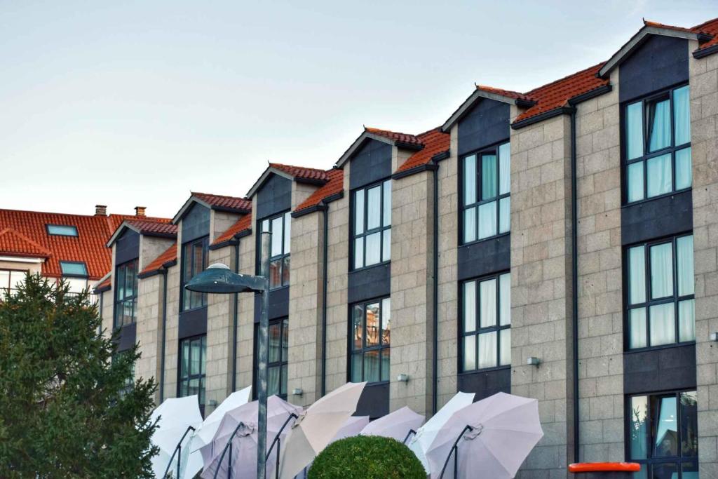 a group of umbrellas in front of a building at Hotel Alda Carril in Vilagarcia de Arousa