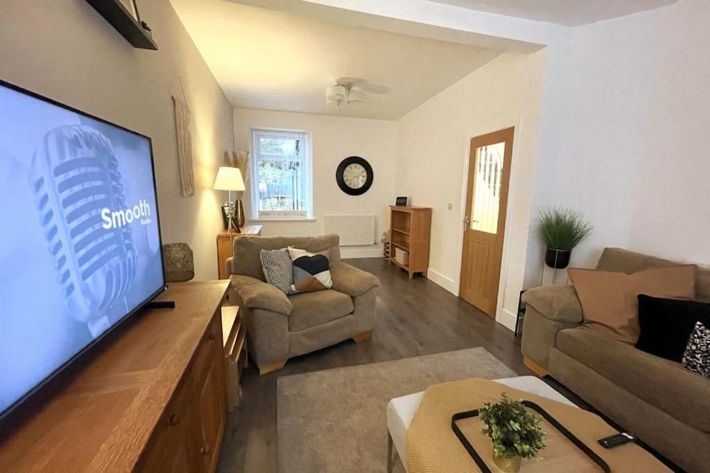 a living room with a large flat screen tv at Modern, spacious and Central Location in Aberdare