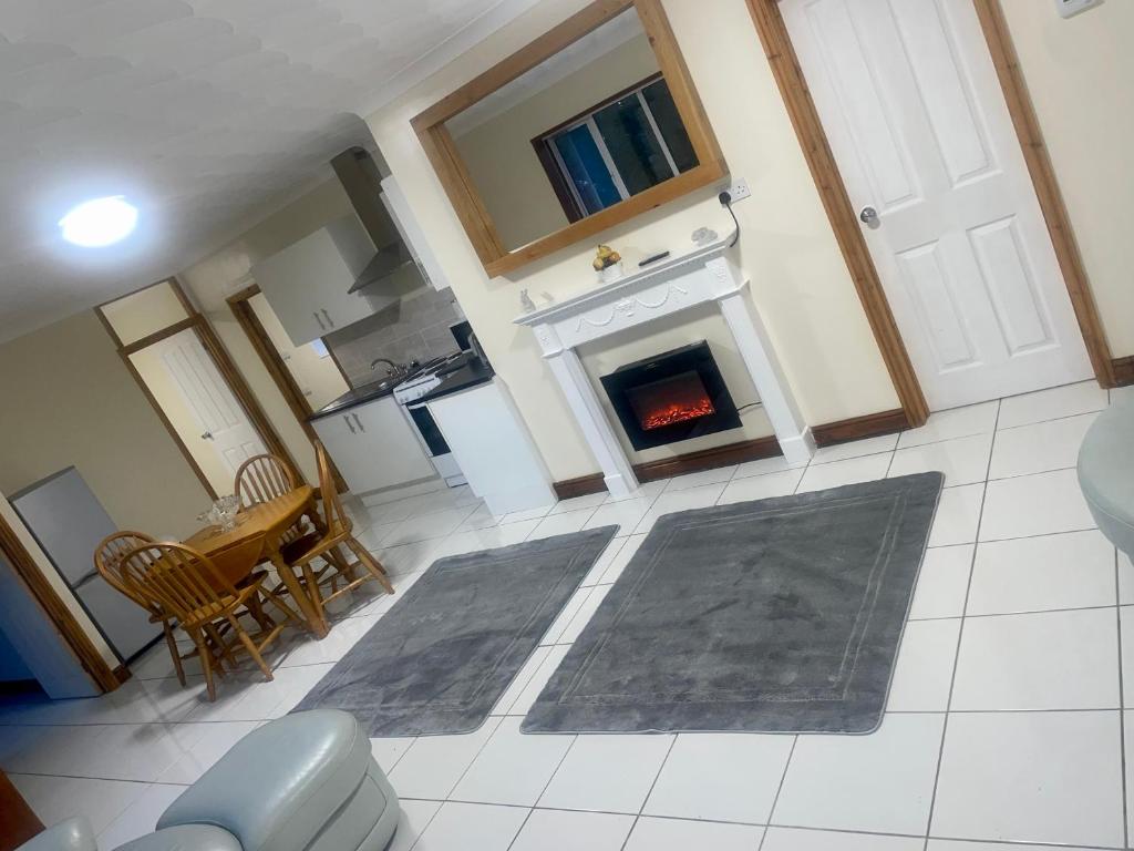 a living room with a fireplace and a rug at Beautiful 3-Bed Bungalow in Bawtry Doncaster in Doncaster