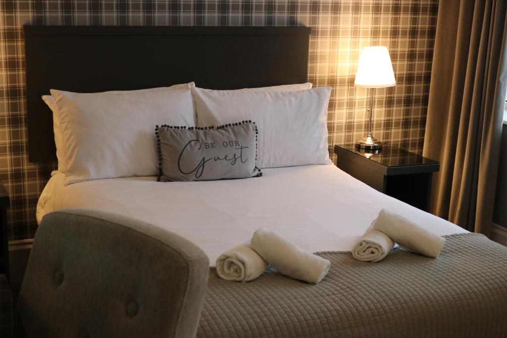 a bedroom with a bed with two towels on it at Norfolk Arms in Glossop