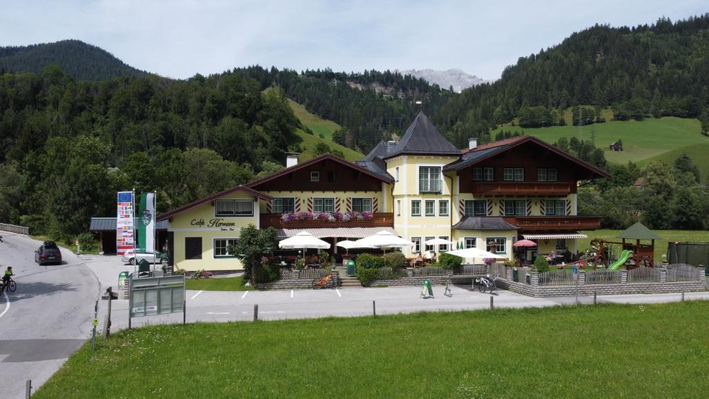 a large building in the middle of a street at Hotel Cafe' Hermann in Schladming