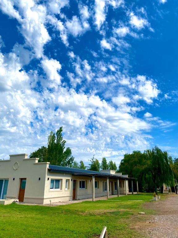un edificio en un campo con un cielo nublado en San Polo departamentos en La Consulta