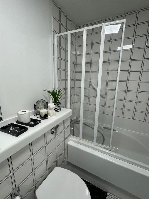 a bathroom with a shower and a toilet and a sink at Perfect in the centre with view in London
