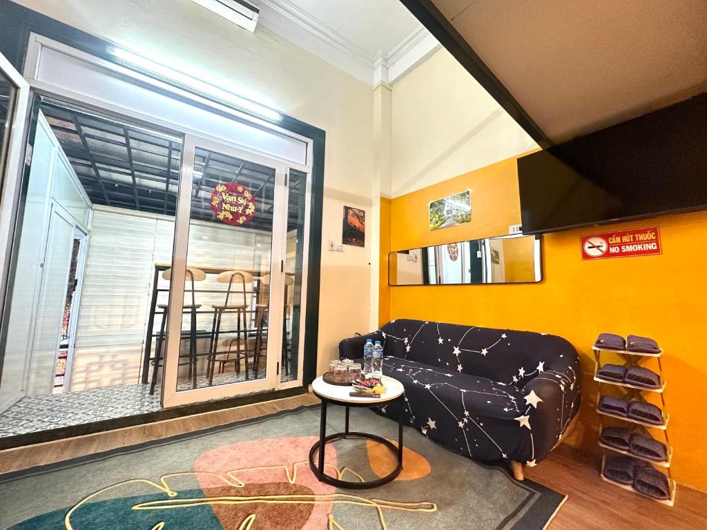 a living room with a couch and a table at Center of Old Quarter, K Home, 1 minute to Hoan Kiem Lake in Hanoi