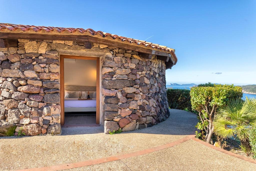 a stone building with a doorway to a bathroom at PedrAmare Suite in Alghero