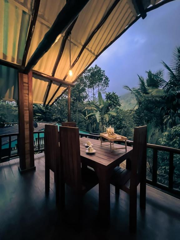 a wooden table and chairs in a room with a view at Haven Harbour in Ella