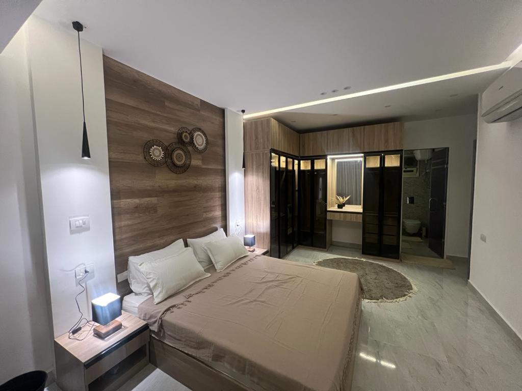 a bedroom with a large bed and a bathroom at 127-3 النيل in Cairo