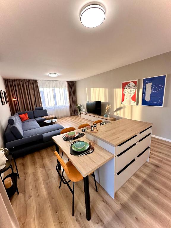 a living room with a table and a couch at Trendy Apartment in Trenčín