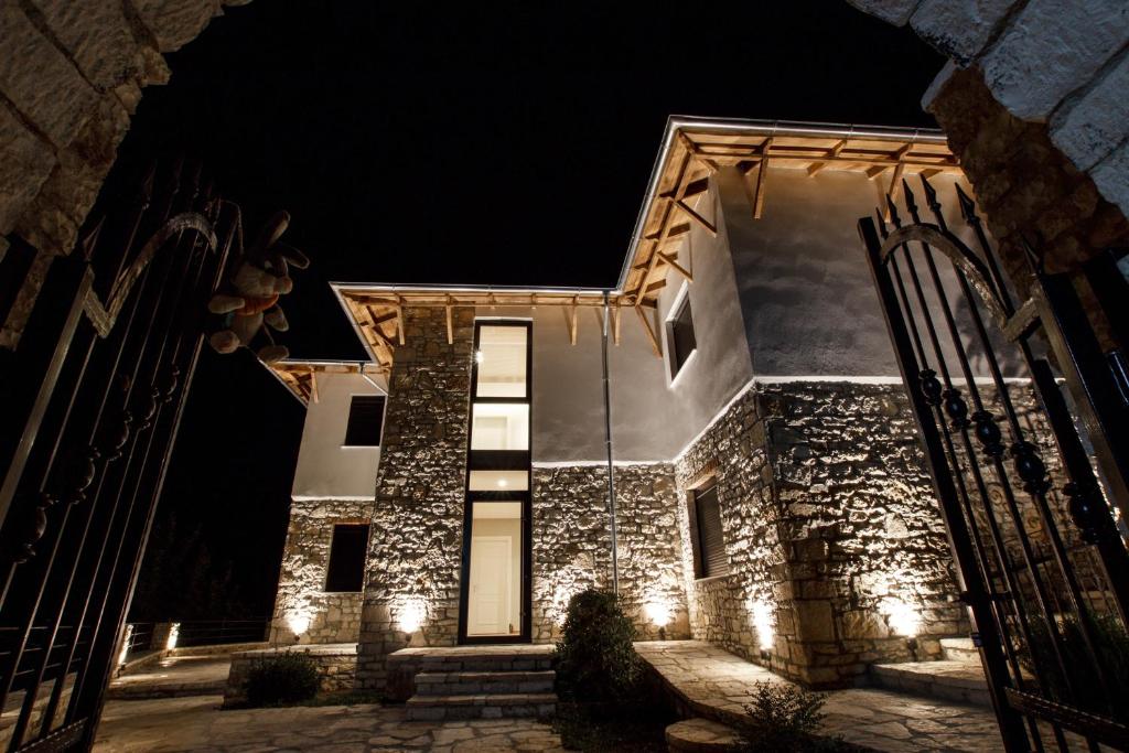 una casa in pietra di notte con luci sopra di Bujtina KOEL a Gjirokastër