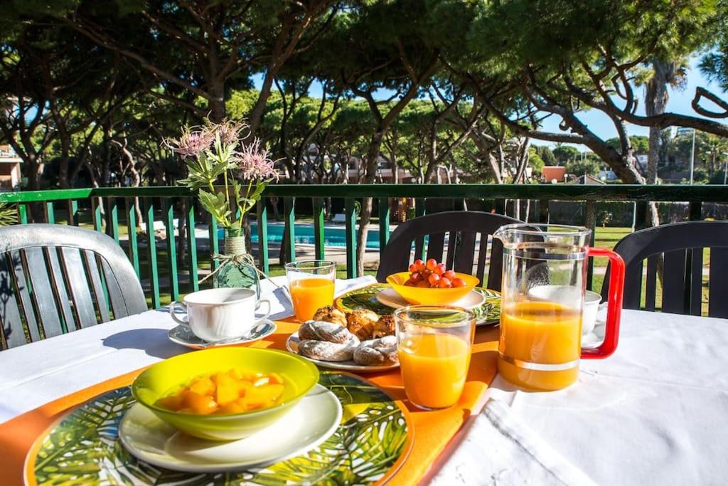 a table with plates of food and glasses of orange juice at Wonderful apartment in Gavà. Barcelona in Gavà